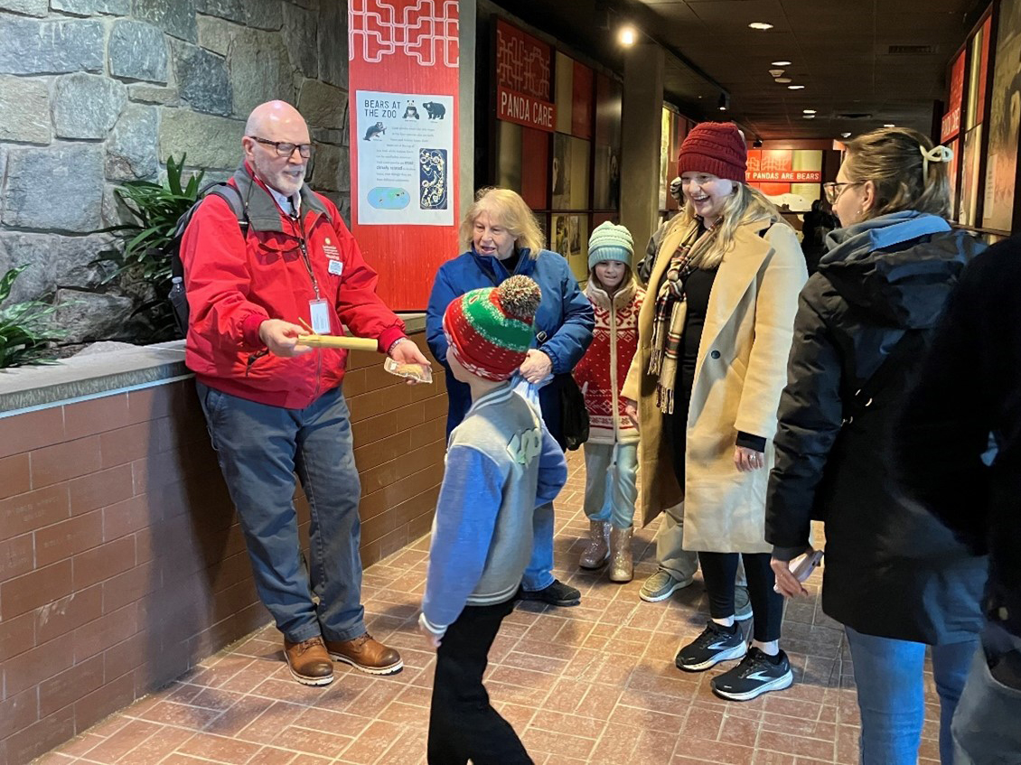 A volunteer engages with the public.